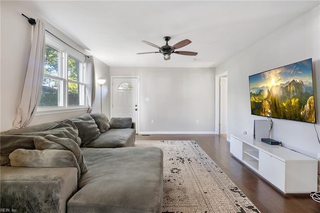 living room with dark hardwood / wood-style floors and ceiling fan