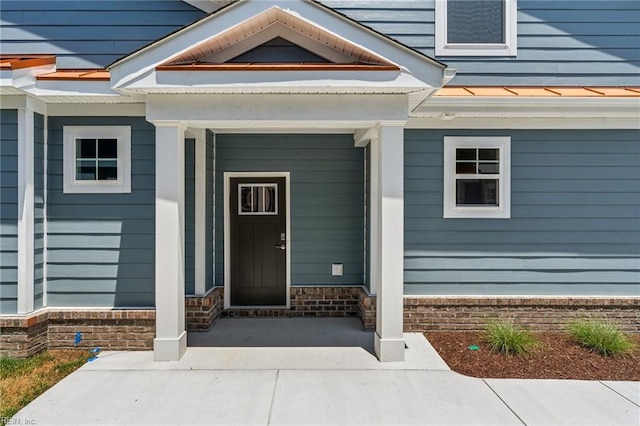 view of exterior entry with a porch