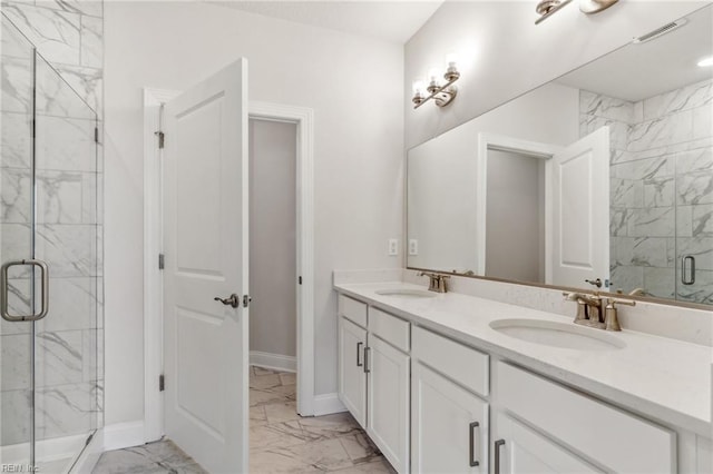 bathroom with vanity and a shower with shower door