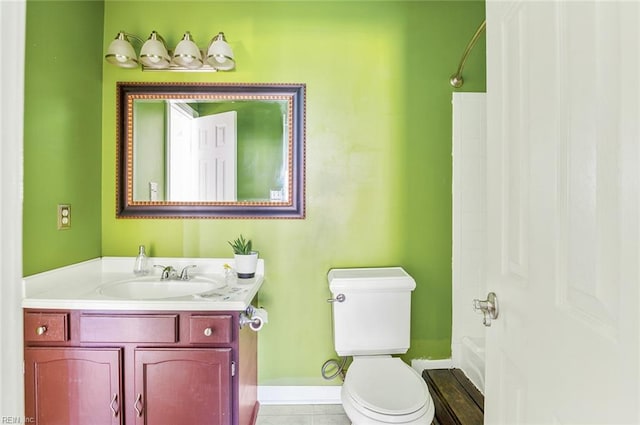 bathroom with toilet, a shower, vanity, and tile patterned floors