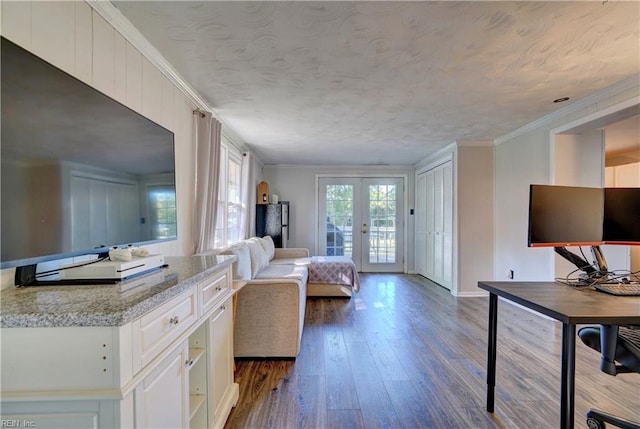 unfurnished bedroom featuring french doors, crown molding, access to outside, and dark hardwood / wood-style flooring