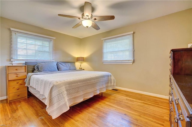 bedroom with light hardwood / wood-style floors and ceiling fan