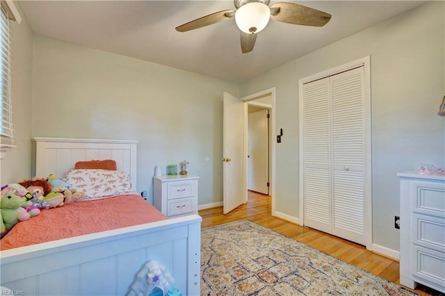 bedroom with light hardwood / wood-style floors, a closet, and ceiling fan