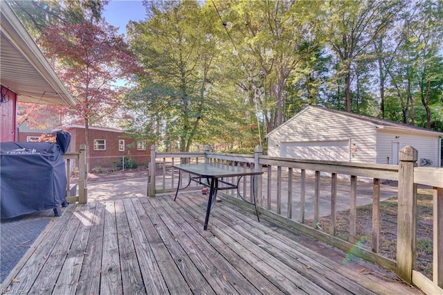 wooden deck with an outbuilding and grilling area