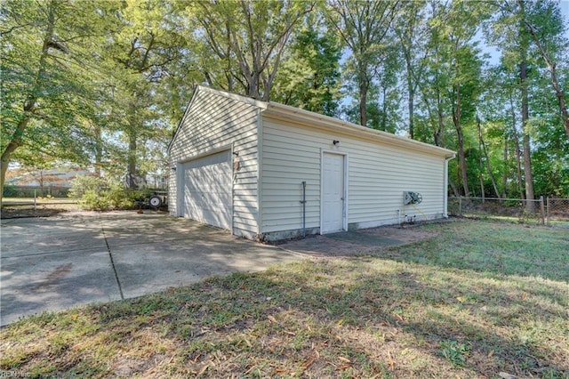 view of outdoor structure featuring a yard and a garage