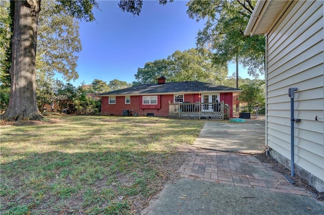 view of yard featuring a wooden deck and central air condition unit