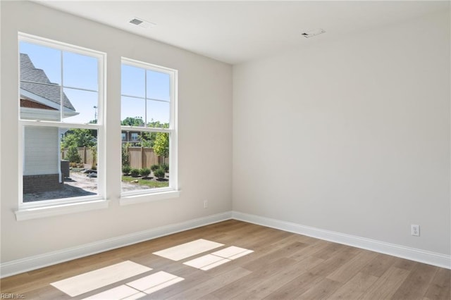 empty room with light hardwood / wood-style floors