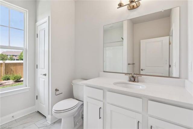 bathroom featuring vanity and toilet