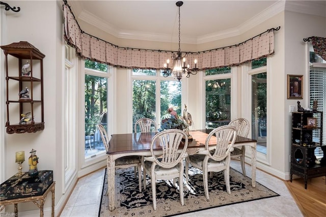 dining area with a notable chandelier, light hardwood / wood-style floors, crown molding, and plenty of natural light