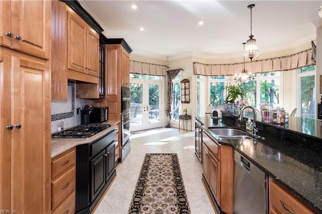 kitchen with french doors, hanging light fixtures, sink, crown molding, and appliances with stainless steel finishes