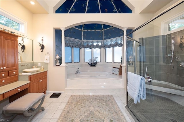 bathroom featuring vanity, tile patterned flooring, separate shower and tub, and decorative columns