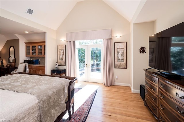 bedroom with french doors, high vaulted ceiling, light hardwood / wood-style flooring, and access to exterior