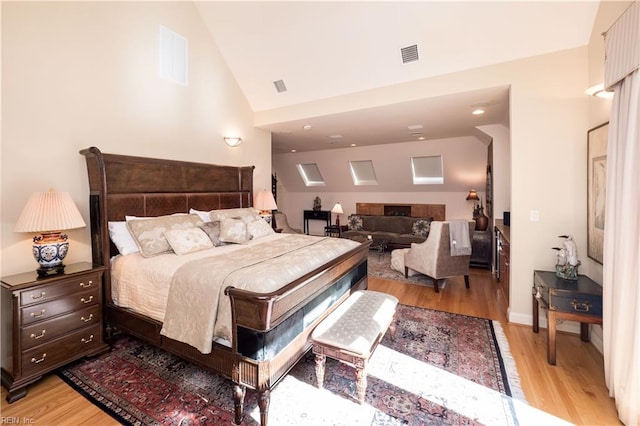 bedroom featuring hardwood / wood-style floors and high vaulted ceiling