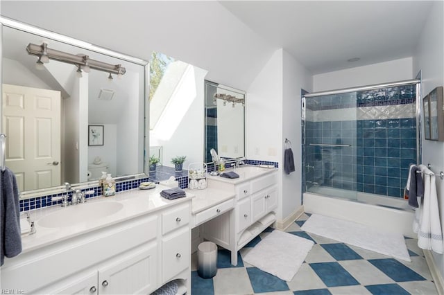 full bathroom with vanity, bath / shower combo with glass door, and toilet