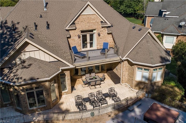 rear view of house featuring a patio area, a balcony, and outdoor lounge area