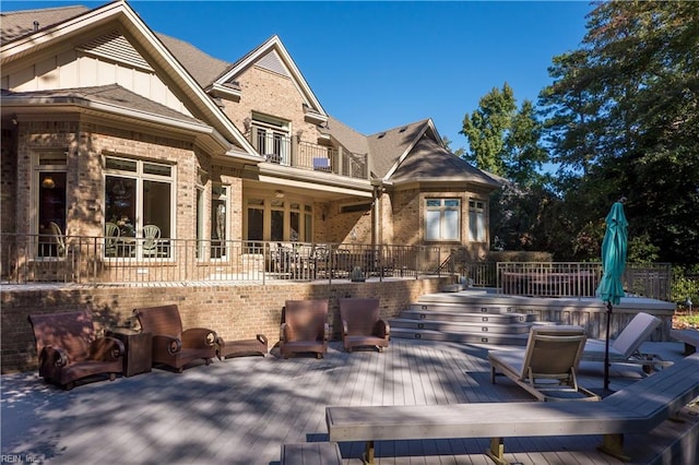 exterior space with a wooden deck and a balcony