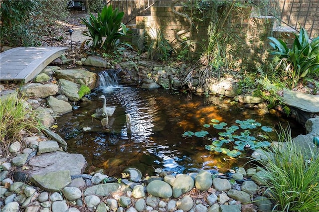 exterior details with a small pond