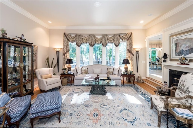 living area with ornamental molding, a notable chandelier, and hardwood / wood-style floors