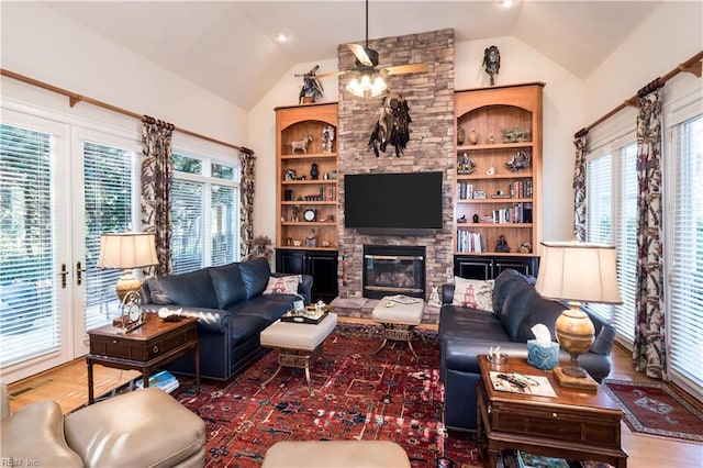 living room with hardwood / wood-style floors, vaulted ceiling, and a healthy amount of sunlight