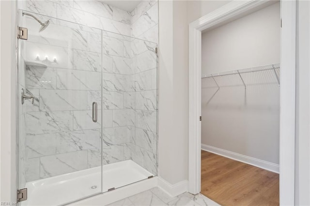 bathroom with an enclosed shower and hardwood / wood-style floors