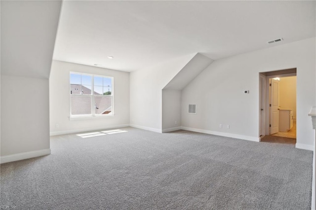 bonus room with lofted ceiling and carpet