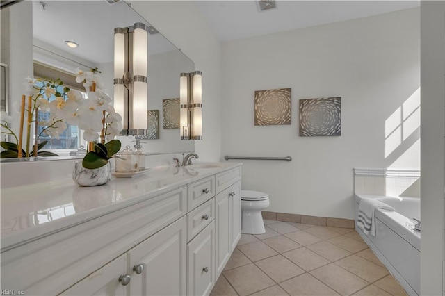 bathroom featuring vanity, tile patterned floors, toilet, and a bathing tub