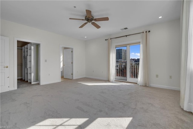 spare room featuring light colored carpet and ceiling fan