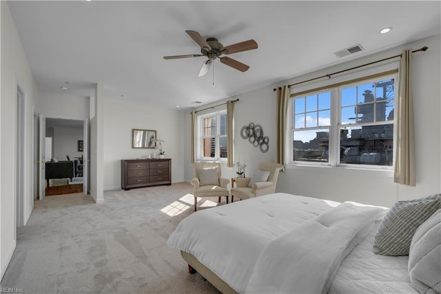 bedroom featuring ceiling fan and light carpet