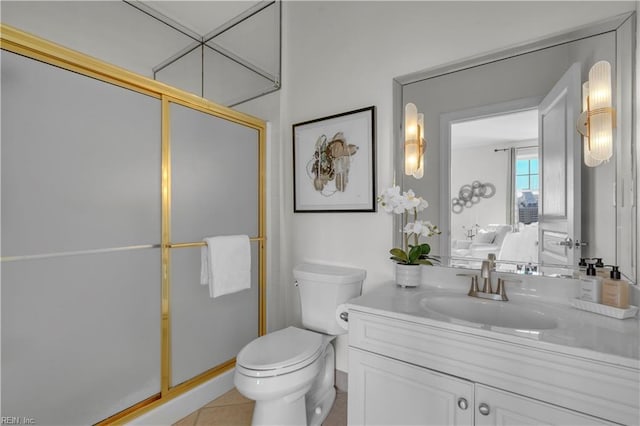 bathroom featuring vanity, toilet, a shower with shower door, and tile patterned flooring