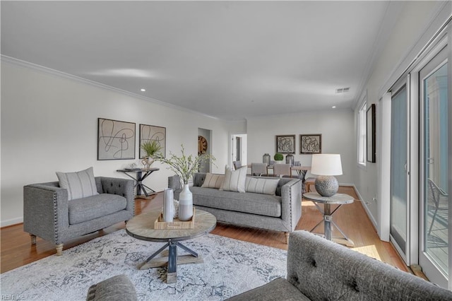 living room with light hardwood / wood-style floors and ornamental molding