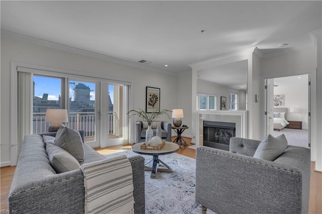 living room featuring light hardwood / wood-style floors and crown molding