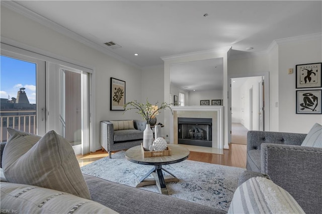 living room with crown molding and light hardwood / wood-style floors