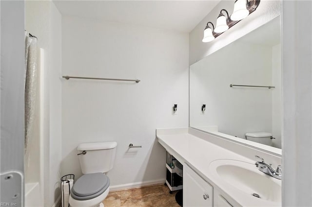 bathroom featuring toilet and vanity