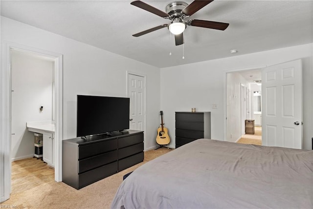 bedroom featuring connected bathroom, ceiling fan, and light colored carpet