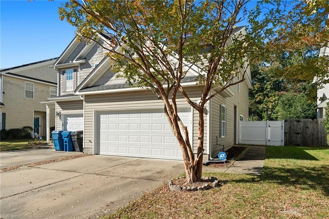 view of side of home with a yard and a garage