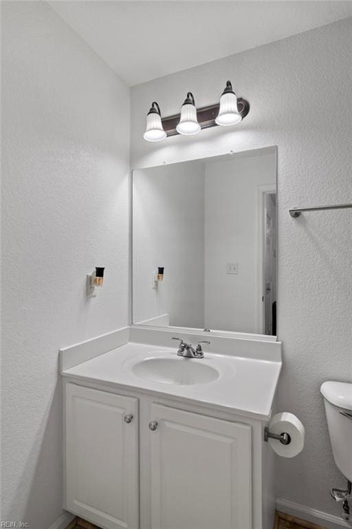 bathroom with toilet and vanity