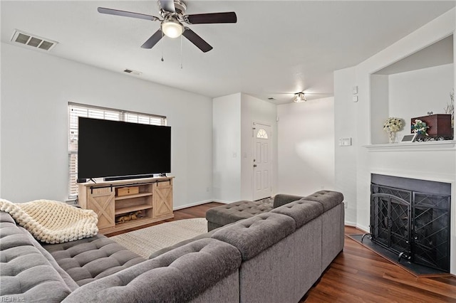 living room with ceiling fan and dark hardwood / wood-style floors