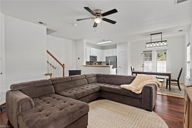 living room featuring ceiling fan and hardwood / wood-style flooring