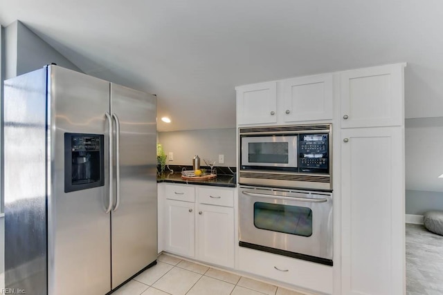 kitchen featuring appliances with stainless steel finishes, white cabinetry, and light tile patterned floors