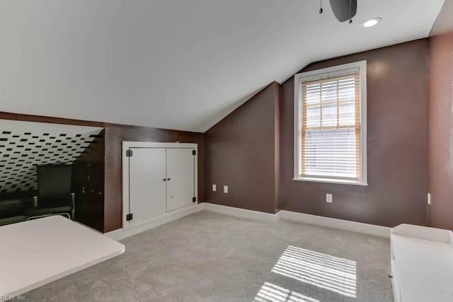 additional living space with vaulted ceiling and light colored carpet