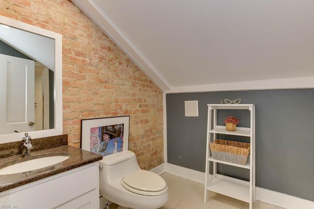 bathroom with toilet, vaulted ceiling, vanity, brick wall, and tile patterned flooring