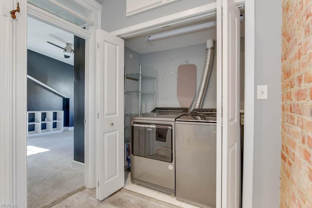 washroom with light carpet, independent washer and dryer, brick wall, and ceiling fan