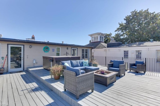 wooden deck with an outdoor living space with a fire pit