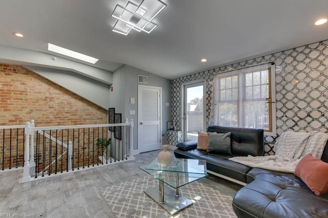 unfurnished living room with lofted ceiling with skylight