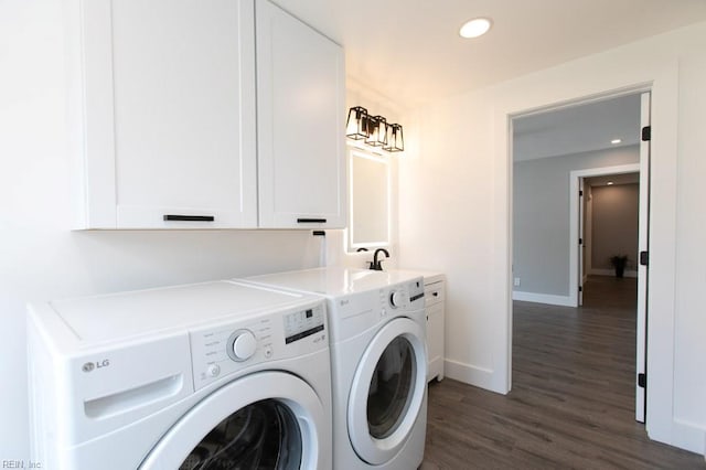 laundry room featuring washer and clothes dryer, sink, cabinets, and dark wood-type flooring