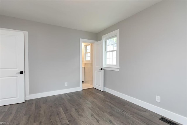 spare room with dark hardwood / wood-style floors