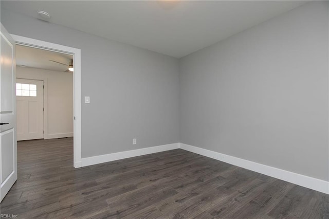 spare room featuring ceiling fan and dark hardwood / wood-style floors