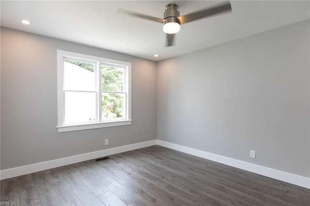 spare room with ceiling fan and dark hardwood / wood-style floors