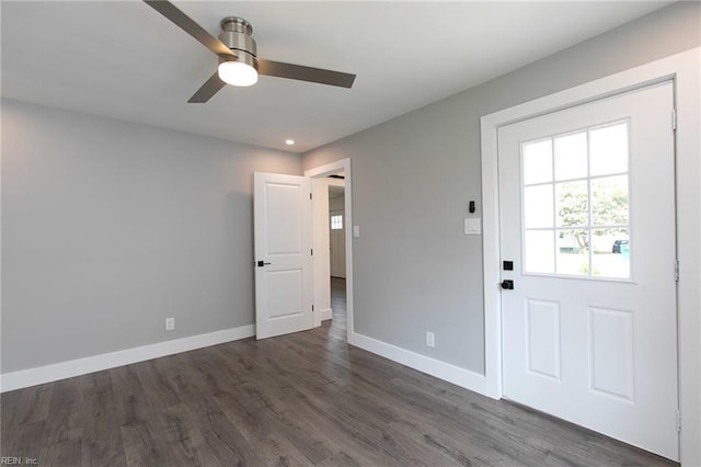 interior space with ceiling fan and dark wood-type flooring