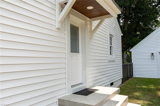 doorway to property featuring a yard